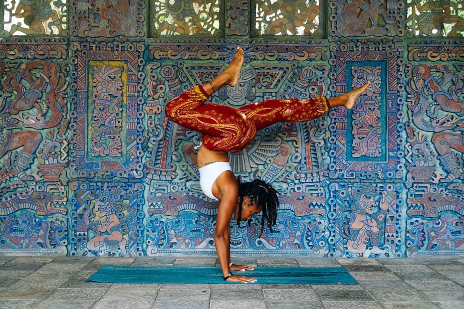 Black women doing a yoga pose outside